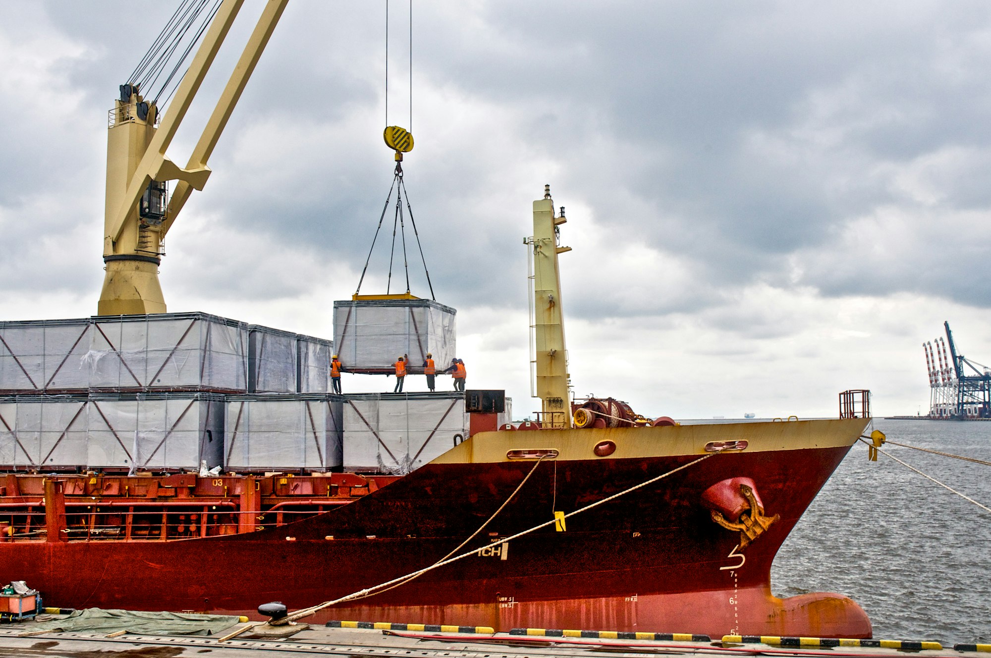 Loading cargo into the ship in harbor